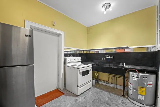 a kitchen with a sink and a refrigerator