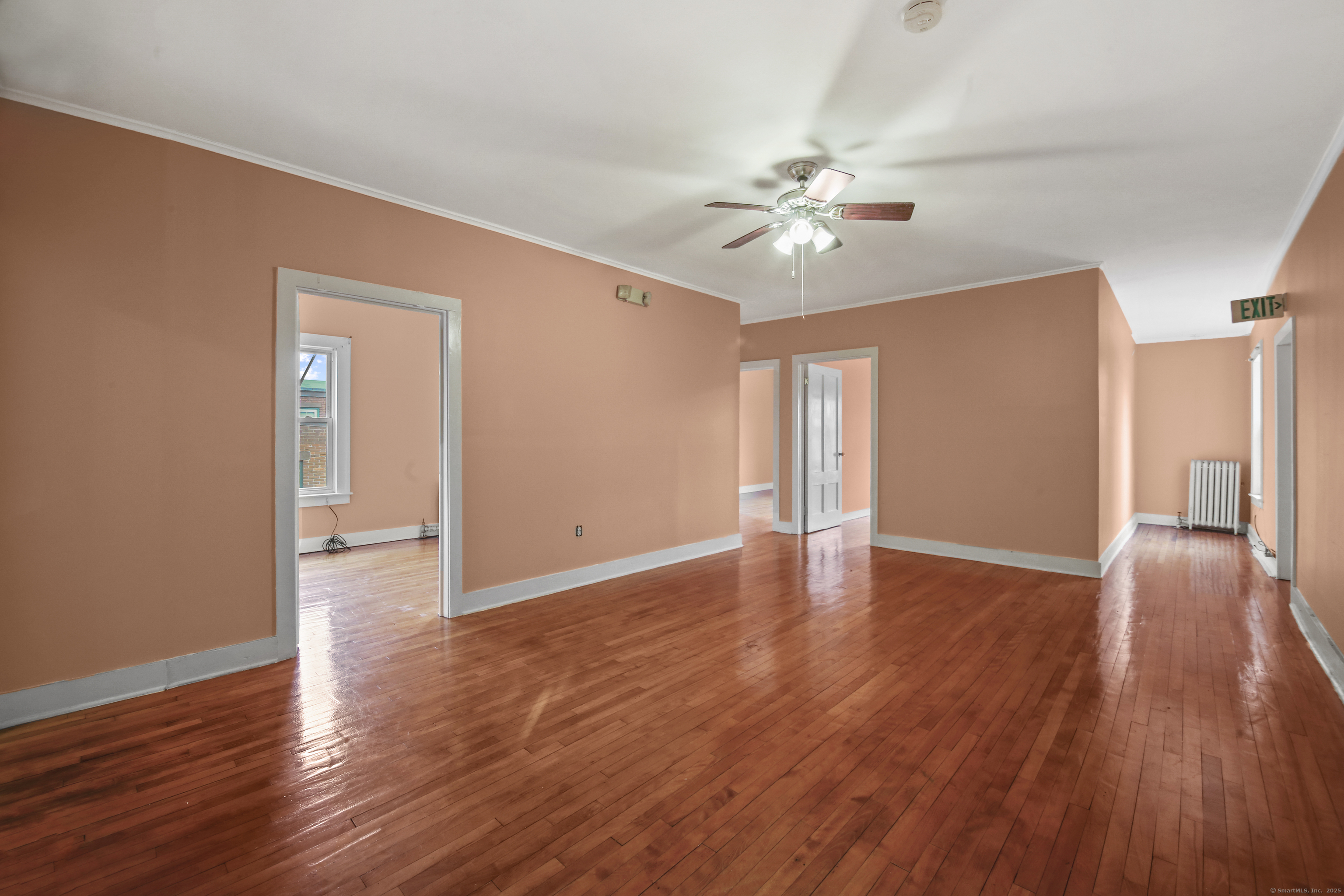 360 Main Street, Unit 3B Middletown, CT 06457 - Photo 17 of 24 a view of an empty room with wooden floor and a ceiling fan