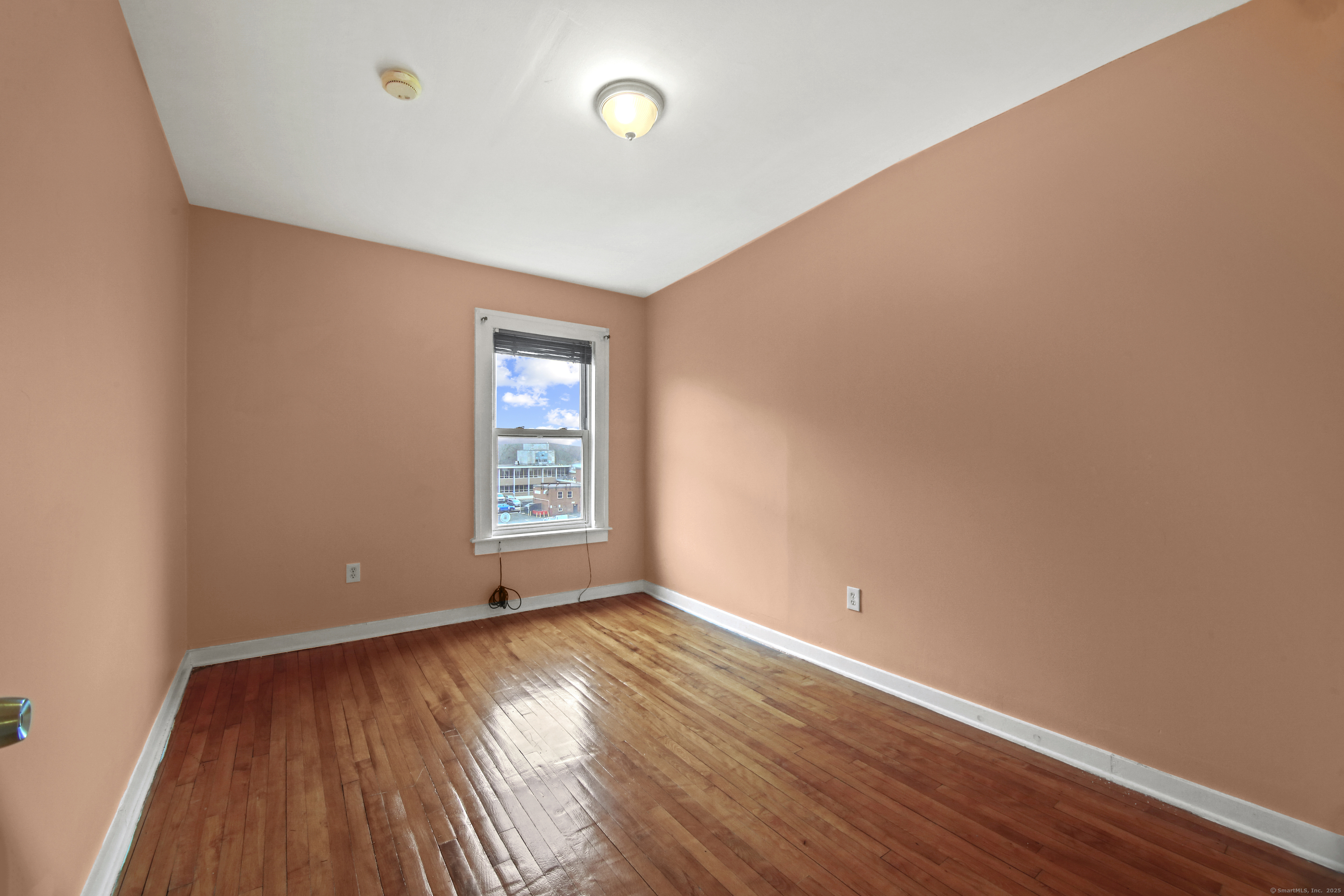 360 Main Street, Unit 3B Middletown, CT 06457 - Photo 21 of 24 an empty room with wooden floor and windows