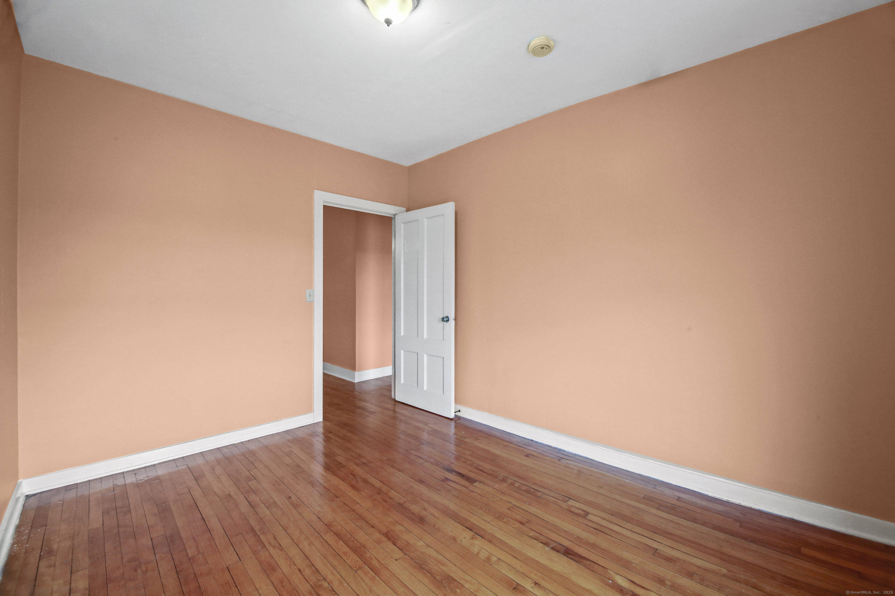 360 Main Street, Unit 3B Middletown, CT 06457 - Photo 22 of 24 a view of an empty room with wooden floor