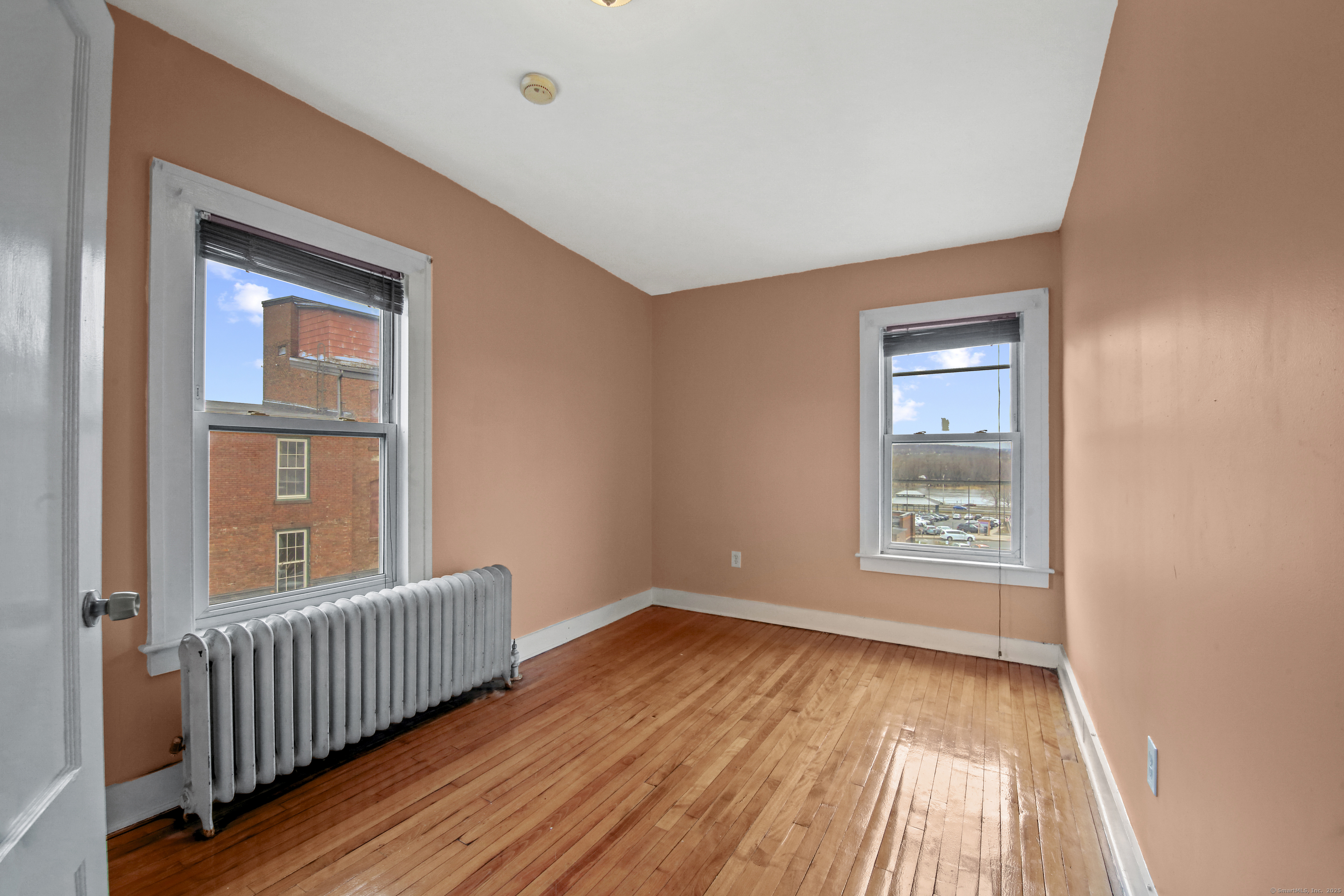 360 Main Street, Unit 3B Middletown, CT 06457 - Photo 23 of 24 a view of an empty room with wooden floor and a window