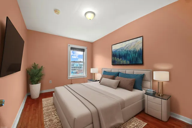 a bedroom with a bed and a flat screen tv