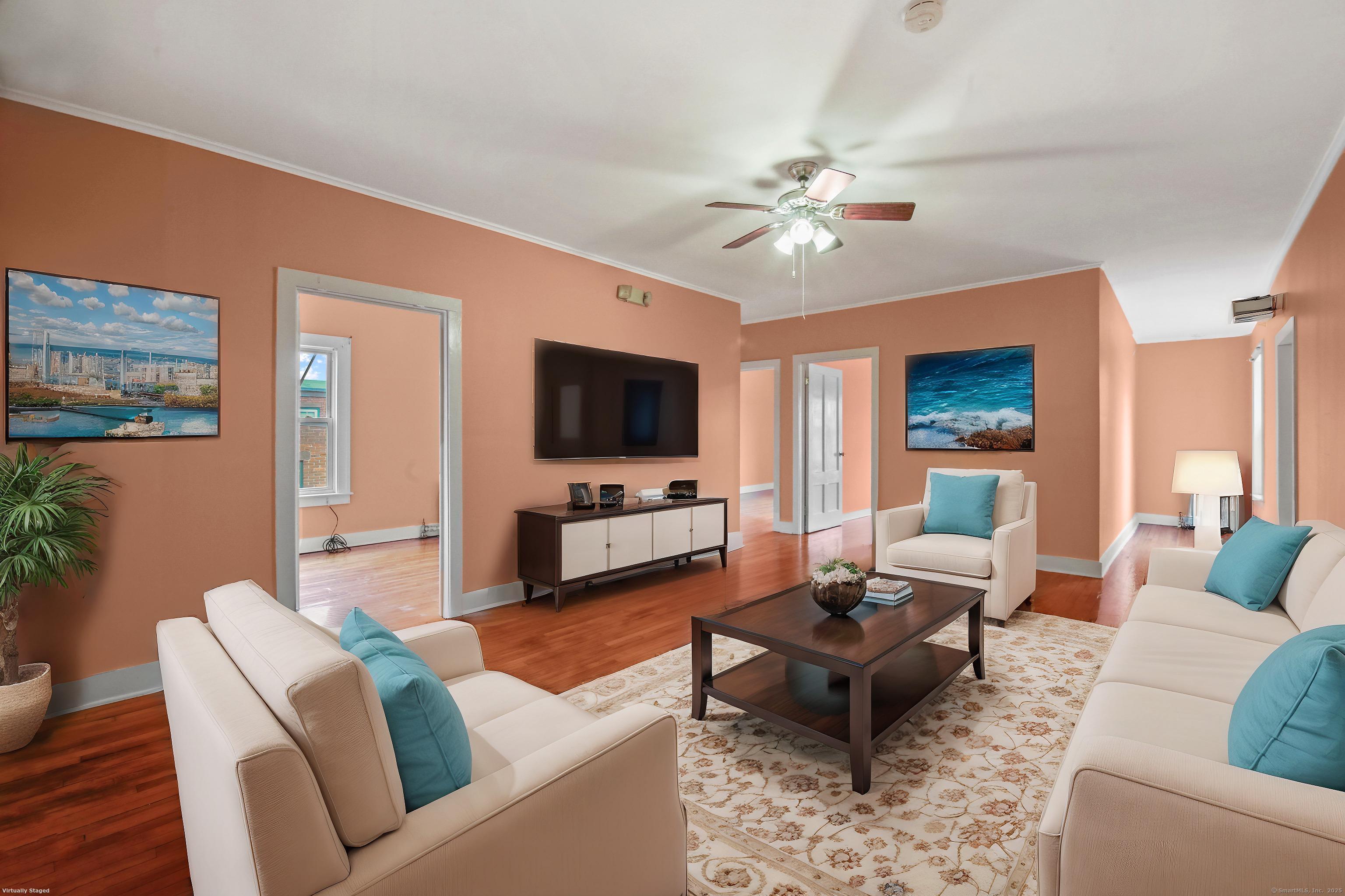 360 Main Street, Unit 3B Middletown, CT 06457 - Photo 8 of 24 a living room with furniture a flat screen tv and kitchen view