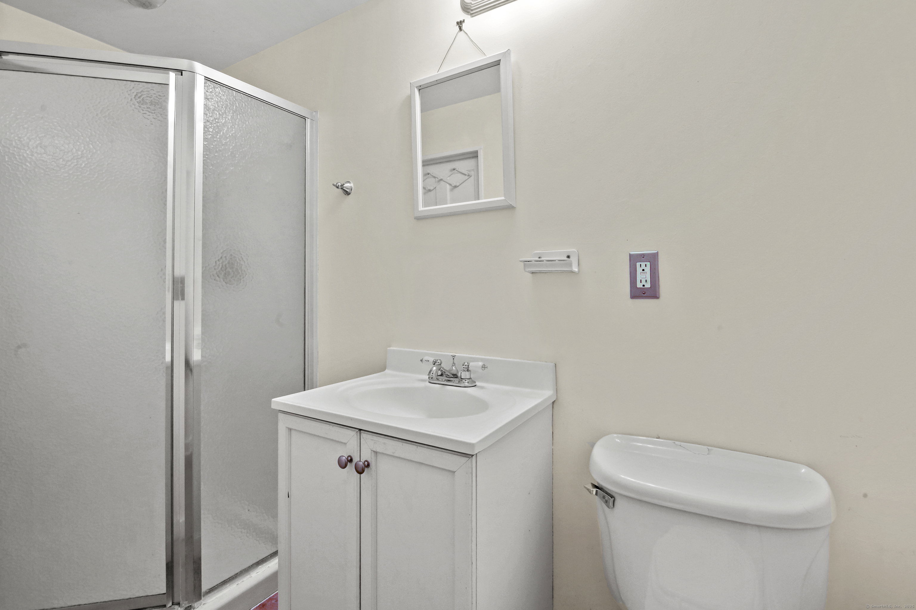 360 Main Street, Unit 3B Middletown, CT 06457 - Photo 10 of 24 a bathroom with a sink a toilet and a mirror
