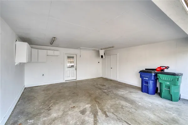 a view of a room with an empty space and a window