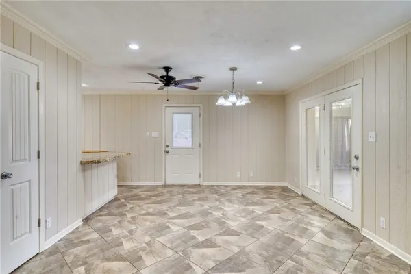 a view of an empty room and kitchen view