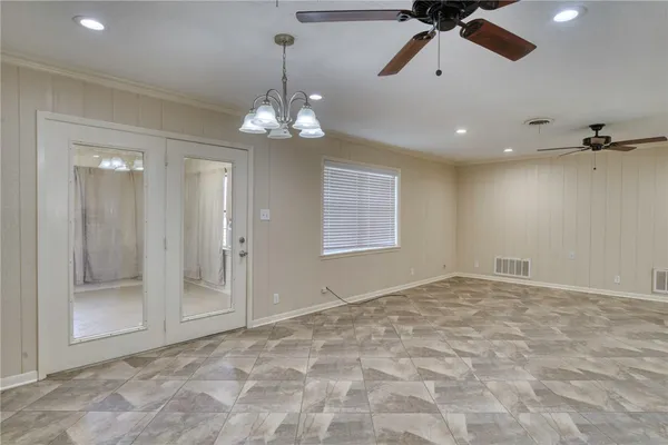 a view of an empty room with a chandelier