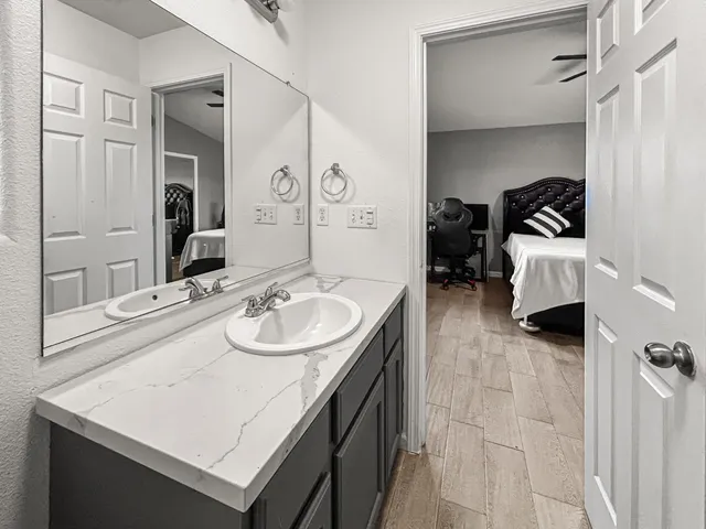 a en suite bathroom with a sink double vanity and a mirror