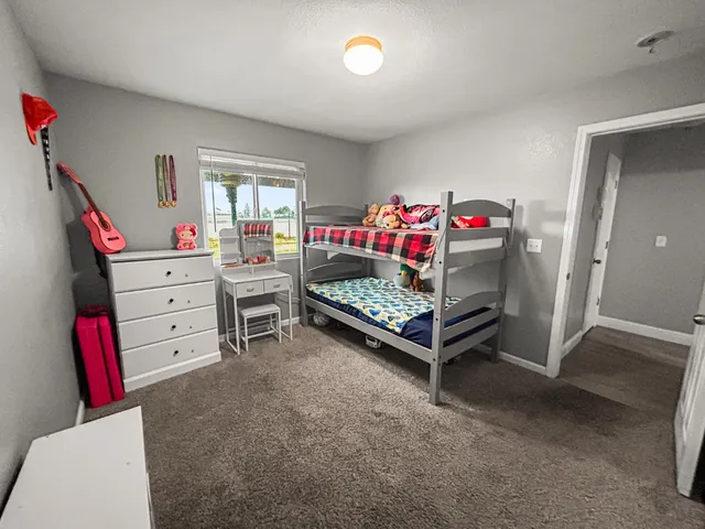 a bedroom with furniture and a baby crib