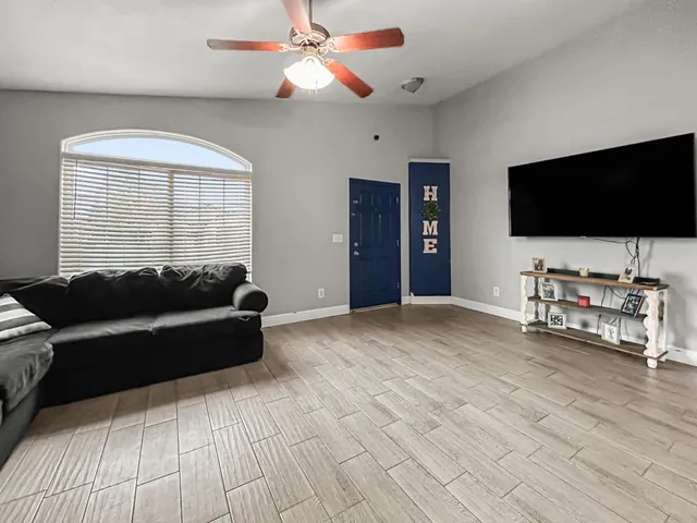 a living room with furniture and a flat screen tv