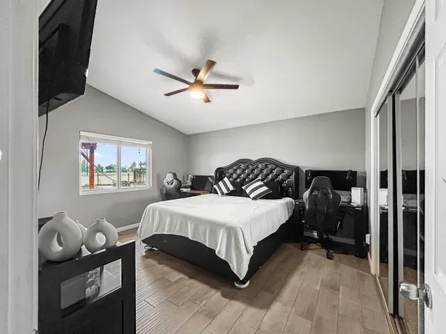 a bedroom with a bed and a chandelier