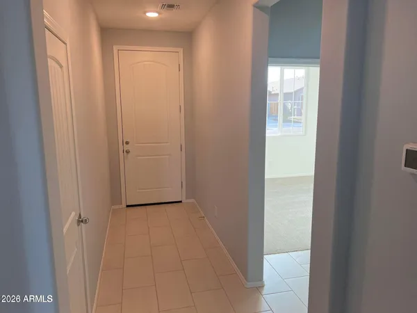 a view of an empty room and closet area