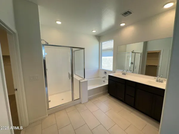 a bathroom with a double vanity sink mirror and shower