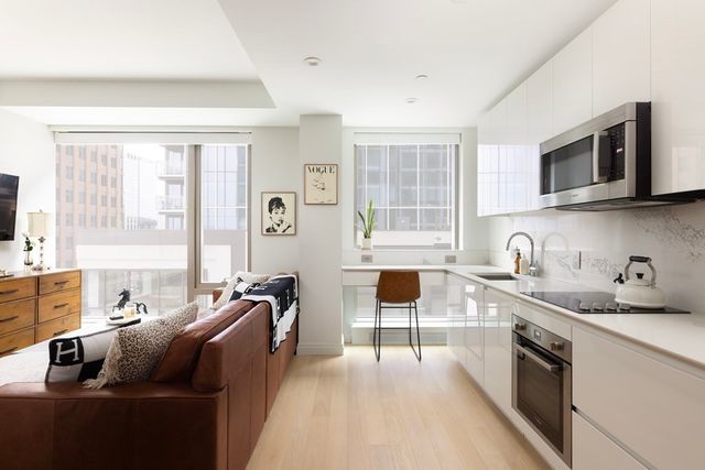 a kitchen with stainless steel appliances granite countertop a sink stove and cabinets