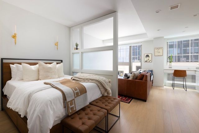 a bedroom with bed couch and window