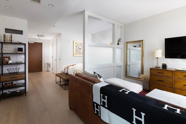 a bedroom with a bed and flat screen tv