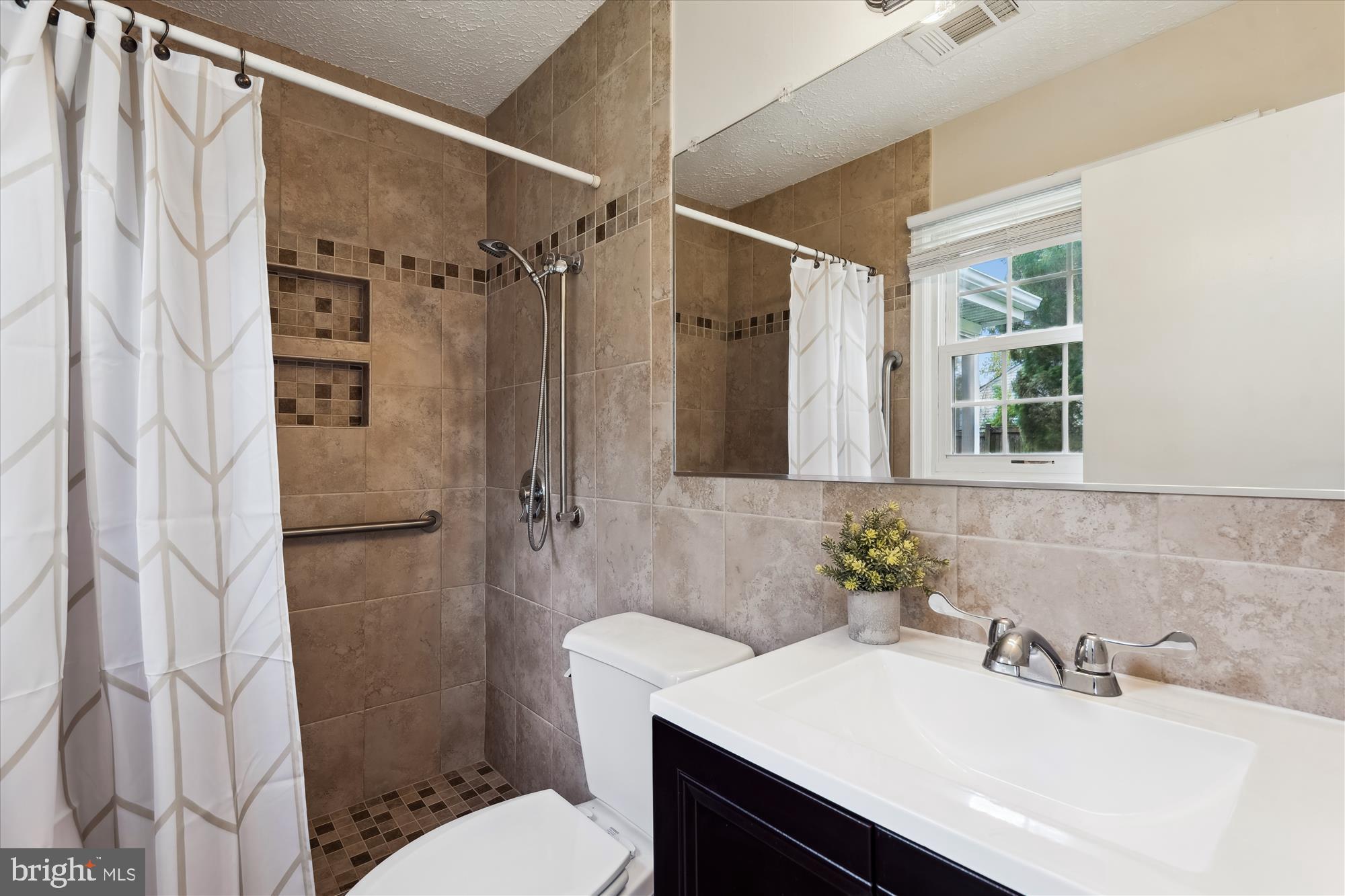 15705 Bond Mill Road Laurel, MD 20707 - Photo 45 of 77 OWNER'S BATH W/ WALK-IN SHOWER & STORAGE VANITY