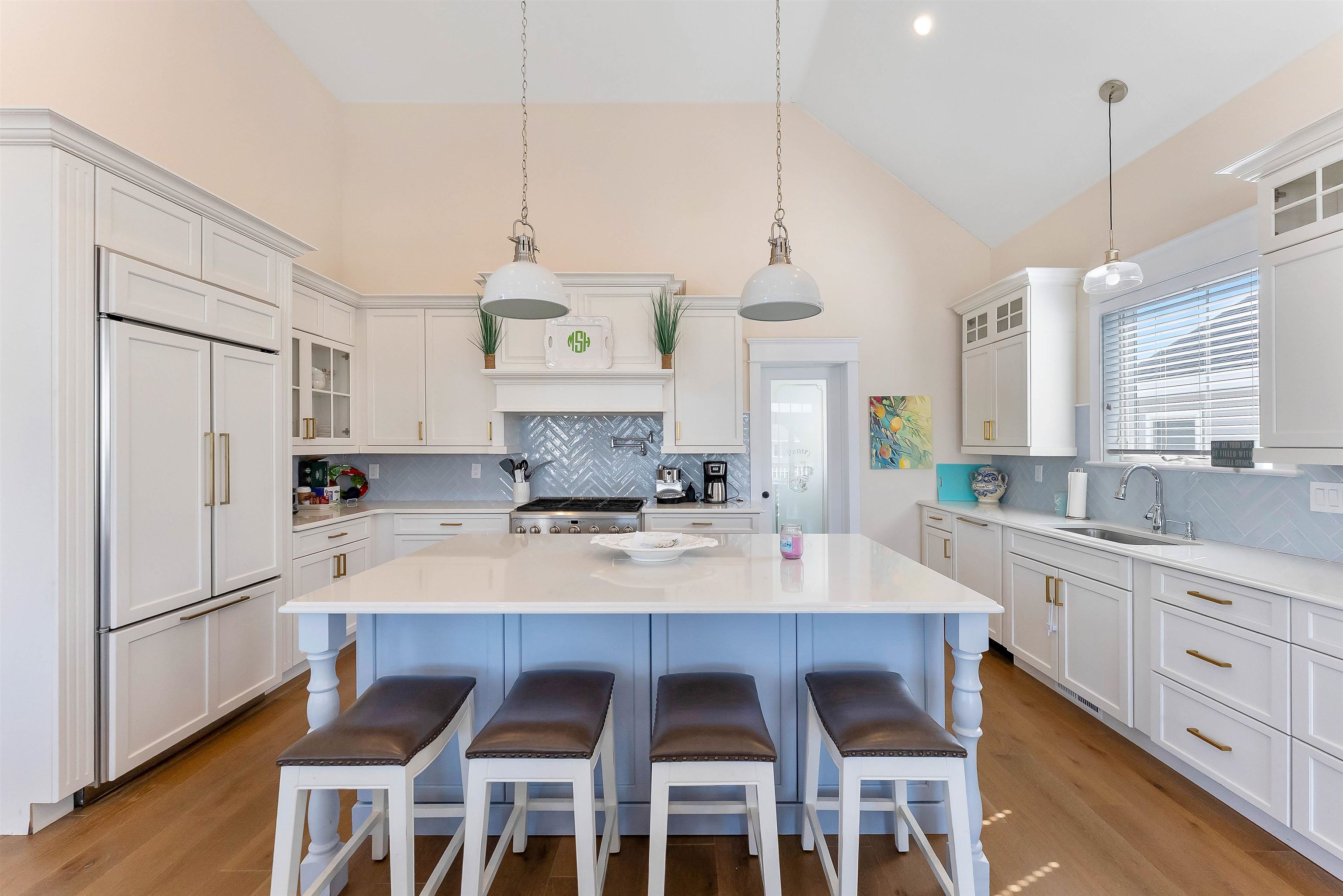 149 10th Street Avalon, NJ 08202 - Photo 24 of 49 a large kitchen with a table chairs refrigerator and microwave