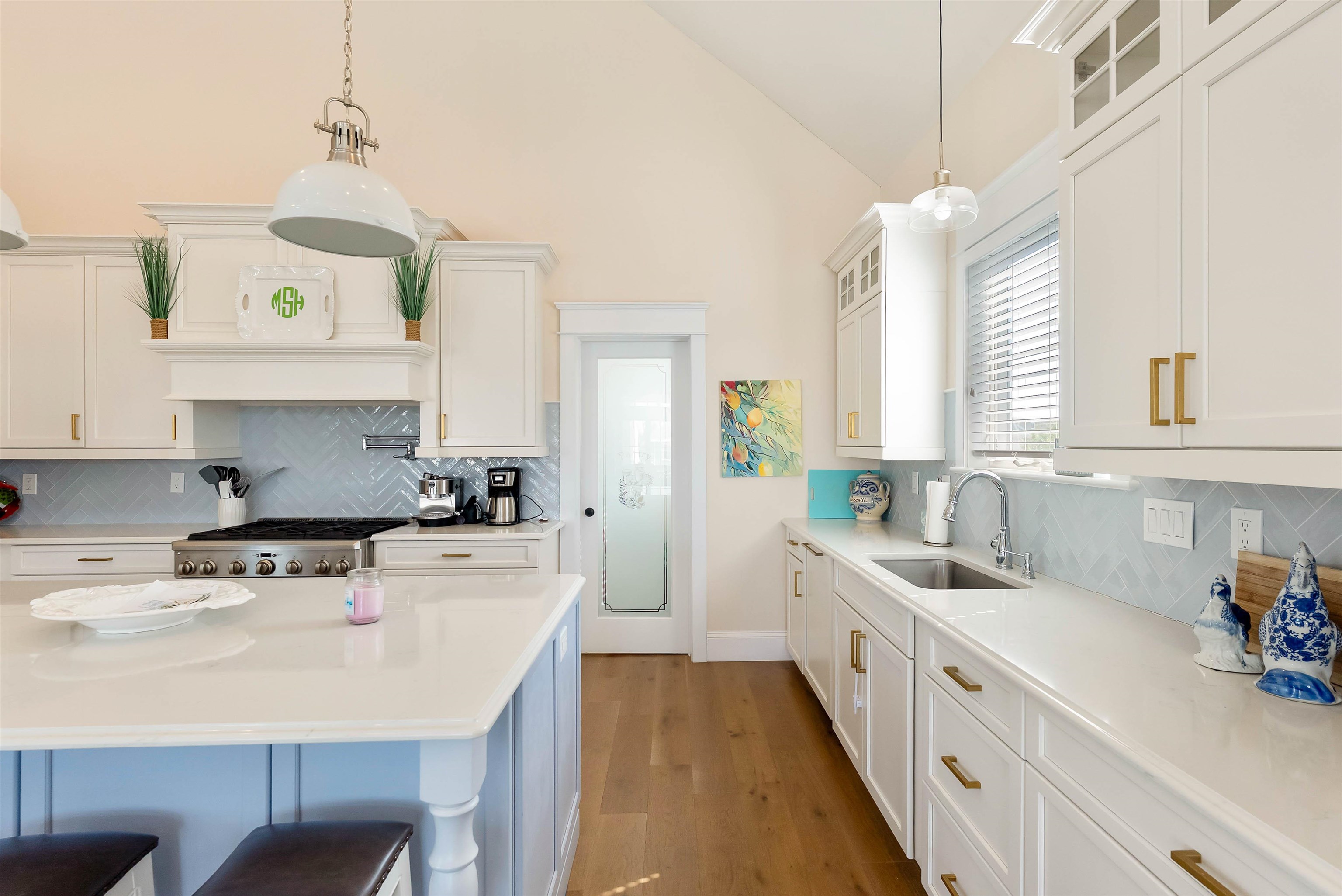 149 10th Street Avalon, NJ 08202 - Photo 25 of 49 a kitchen with a stove a sink a center island and cabinets