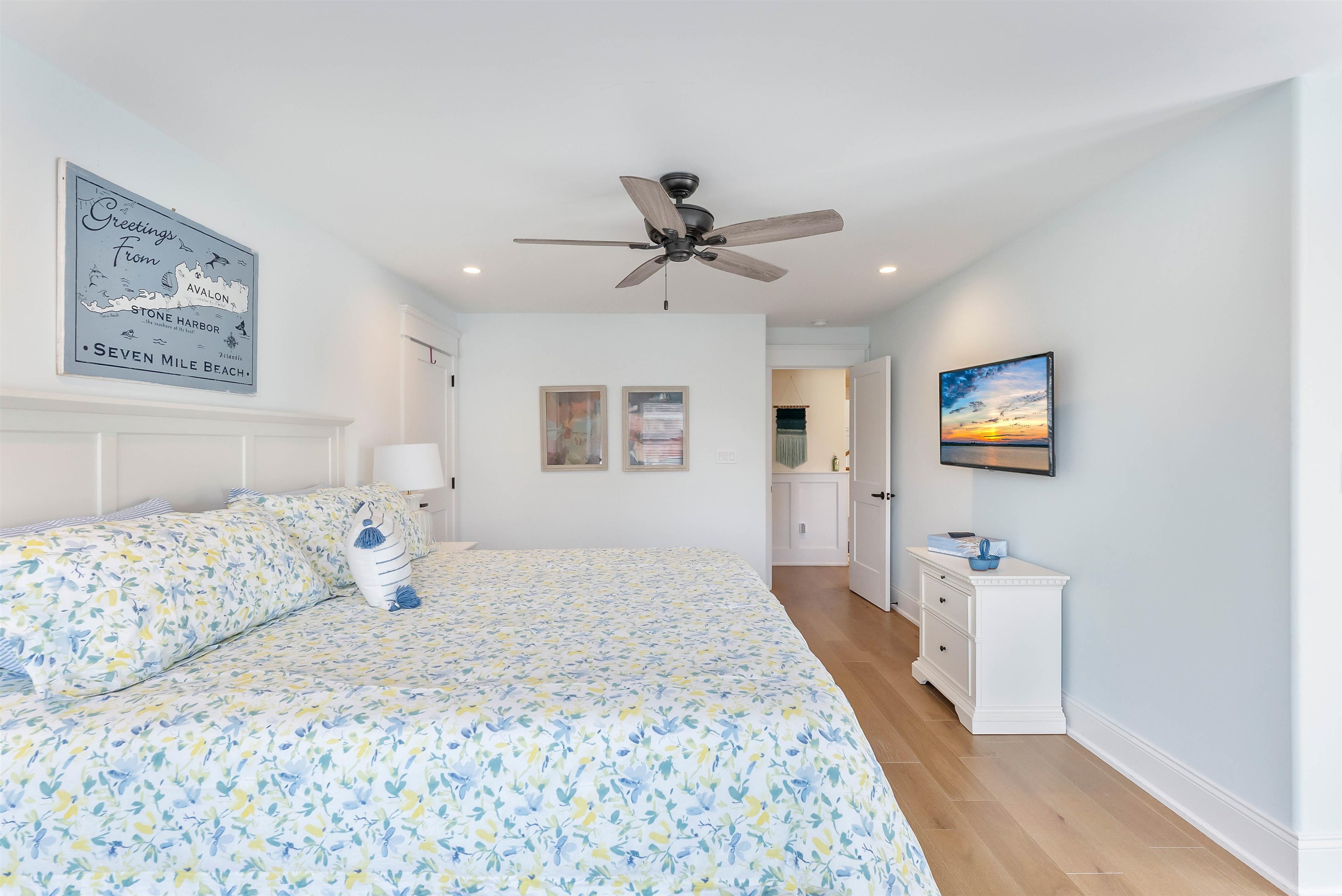 149 10th Street Avalon, NJ 08202 - Photo 33 of 49 a bedroom with a bed and a chandelier