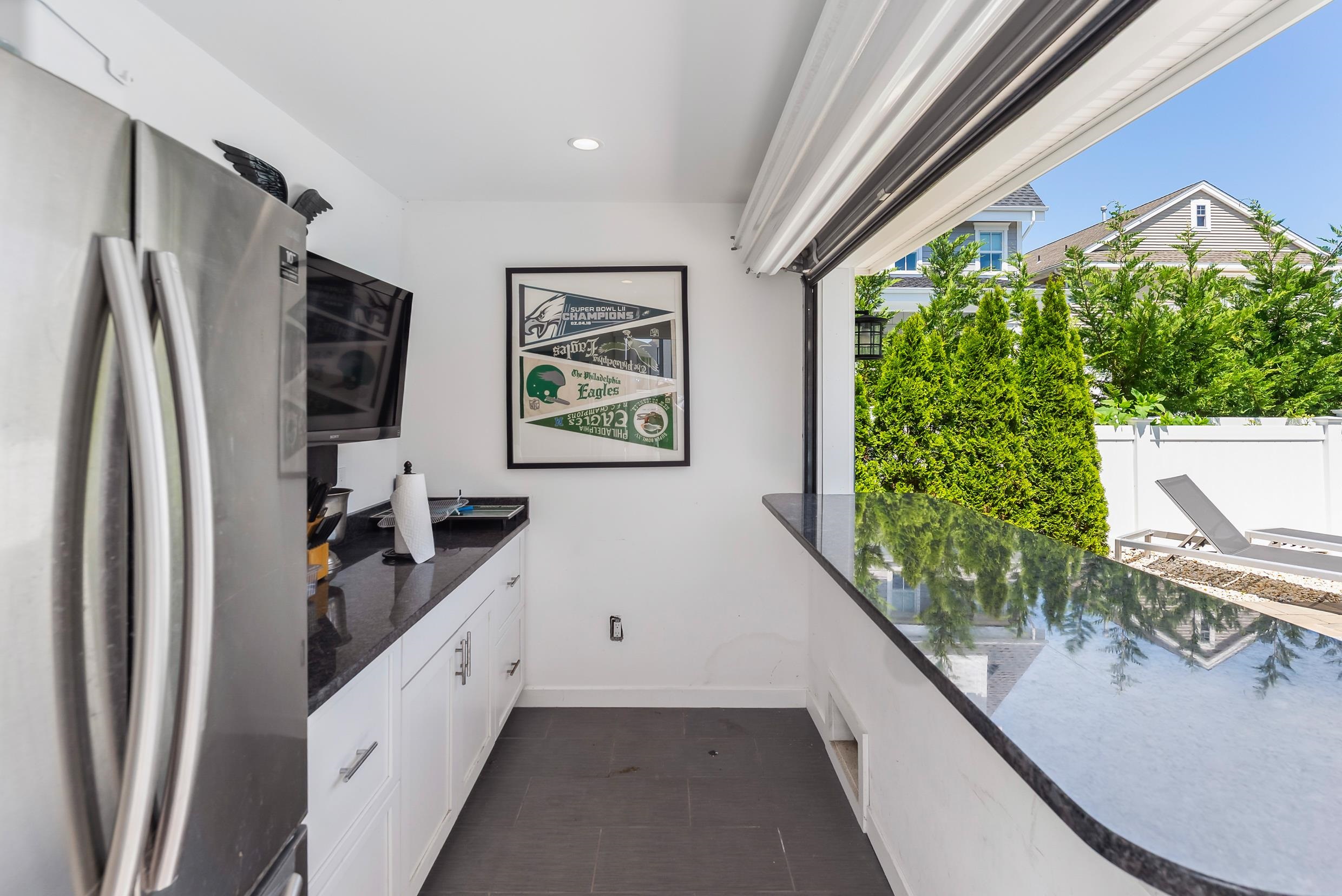 149 10th Street Avalon, NJ 08202 - Photo 46 of 49 a kitchen with stainless steel appliances granite countertop a refrigerator and a sink