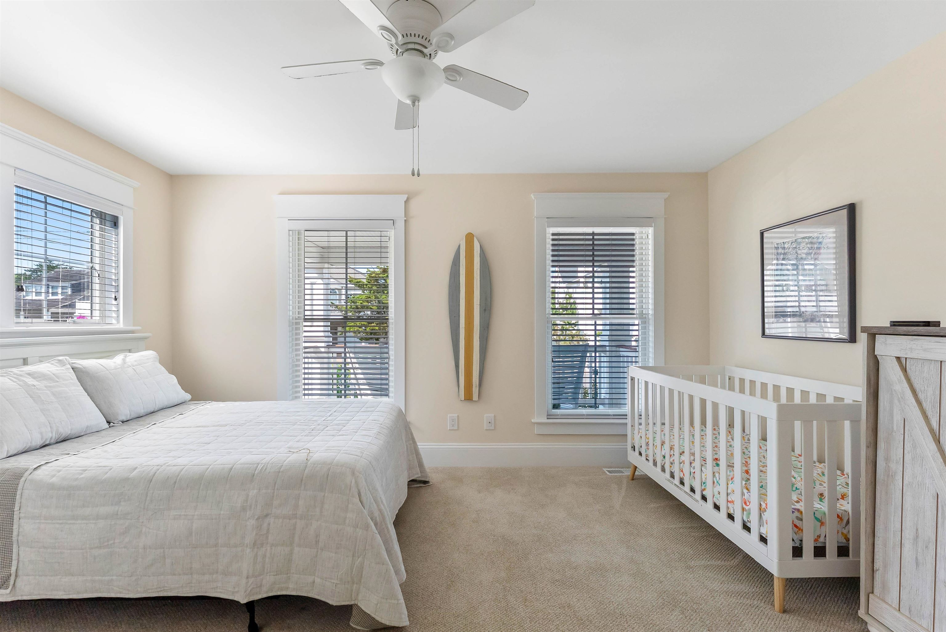 149 10th Street Avalon, NJ 08202 - Photo 6 of 49 a bedroom with a large bed and a chandelier
