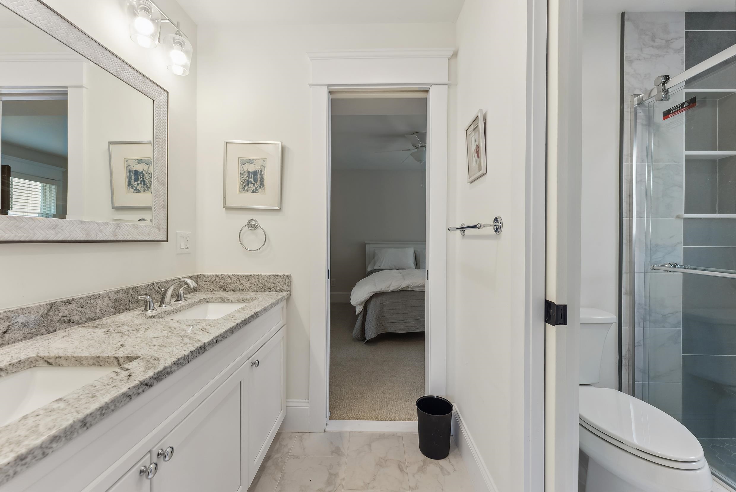 149 10th Street Avalon, NJ 08202 - Photo 8 of 49 a en suite bathroom with a granite countertop sink and a mirror