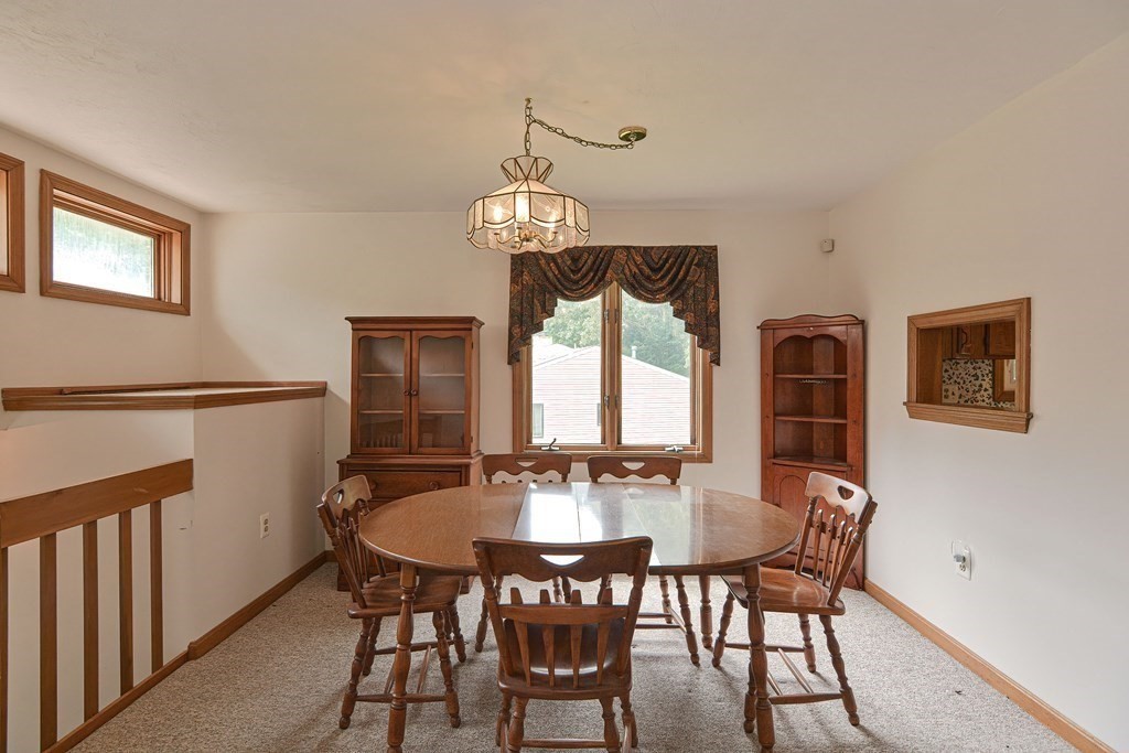 17 Nottingham Road, Unit 17 Grafton, MA 01519 - Photo 17 of 23 a dining room with furniture a chandelier and wooden floor