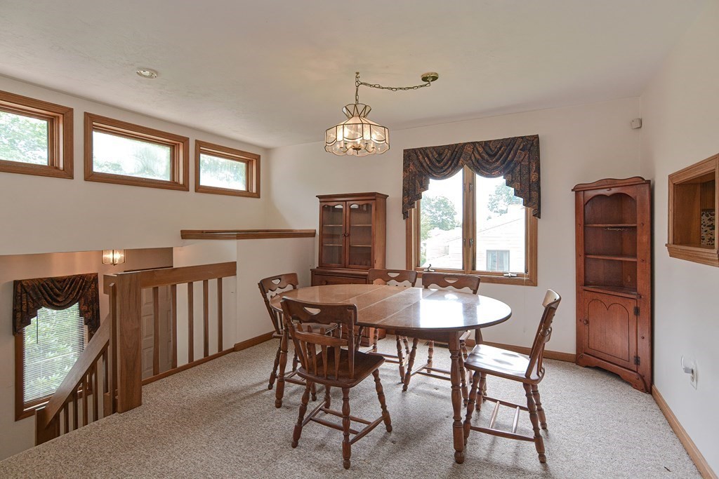 17 Nottingham Road, Unit 17 Grafton, MA 01519 - Photo 6 of 23 a dining room with furniture a chandelier and wooden floor