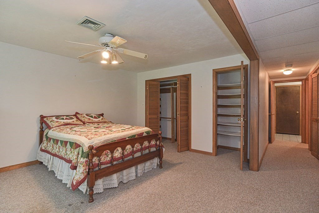 17 Nottingham Road, Unit 17 Grafton, MA 01519 - Photo 7 of 23 a bedroom with a bed and a chandelier