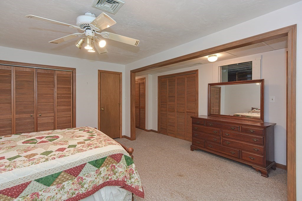 17 Nottingham Road, Unit 17 Grafton, MA 01519 - Photo 8 of 23 a bedroom with a bed and a chandelier