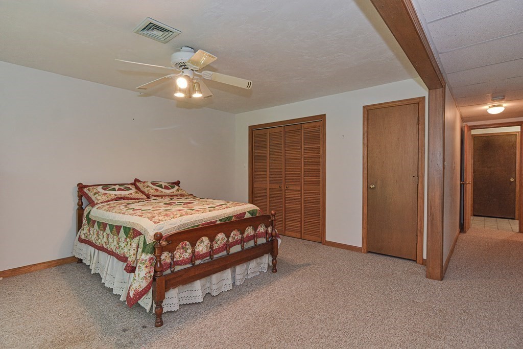 17 Nottingham Road, Unit 17 Grafton, MA 01519 - Photo 9 of 23 a bedroom with a bed and a chandelier