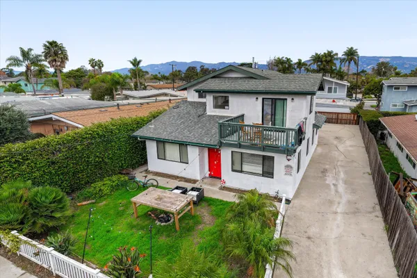 an aerial view of a house with swimming pool garden and patio
