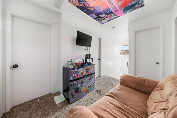 a bedroom with furniture and a flat screen tv