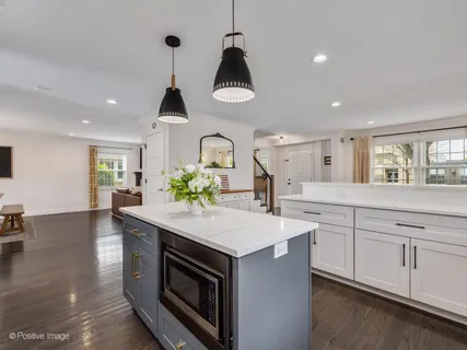 a kitchen with stainless steel appliances a sink and cabinets