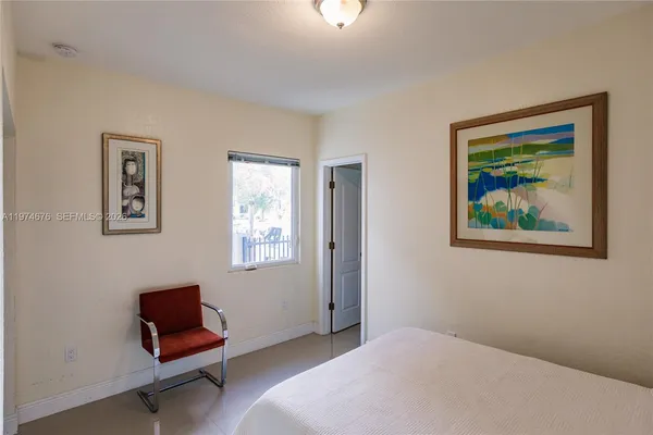a bedroom with a bed and a chair