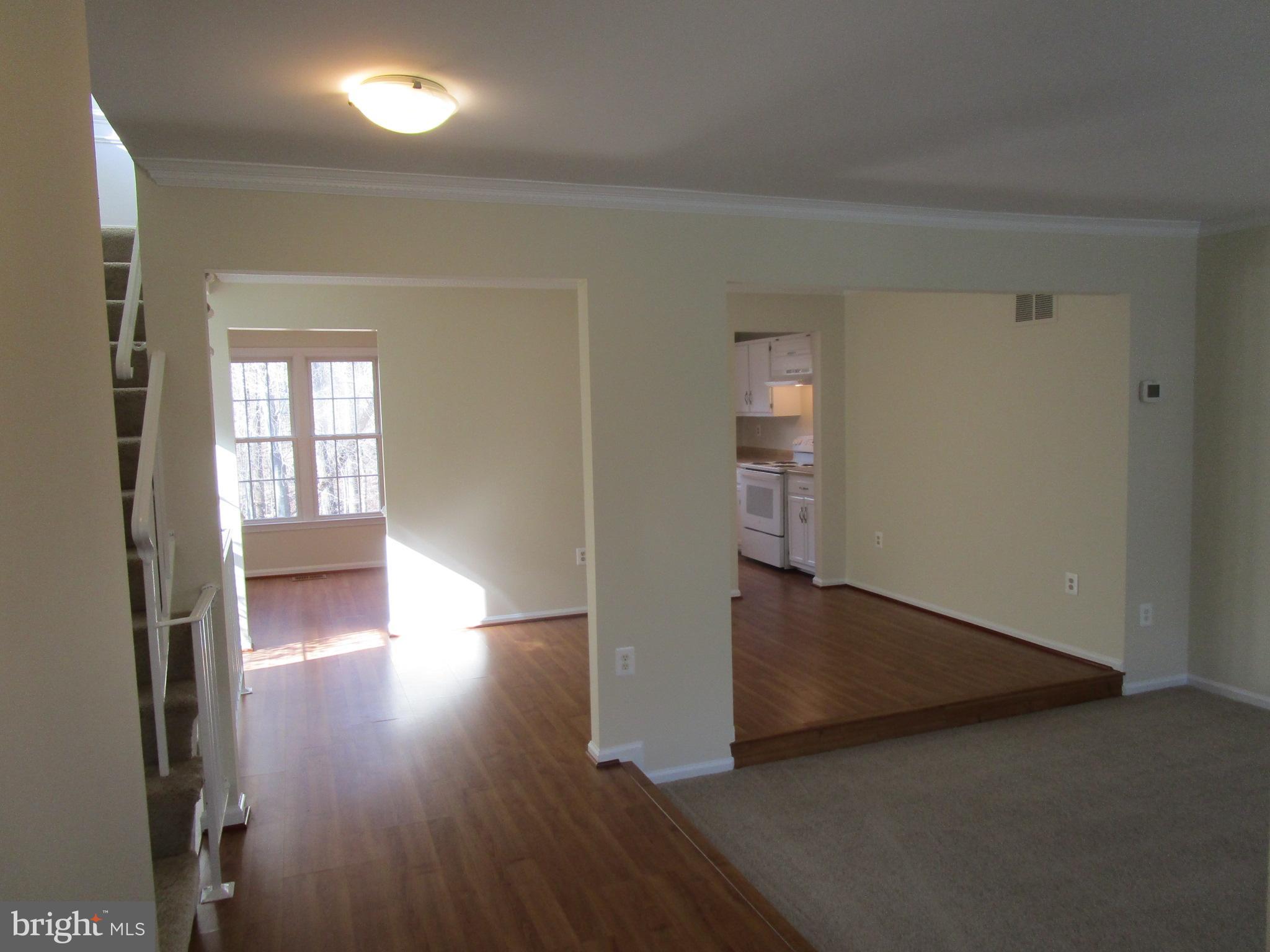 7932 Forest Path Way Springfield, VA 22153 - Photo 7 of 30 Wood Laminate Floors Foyer/Dining & Kitchen