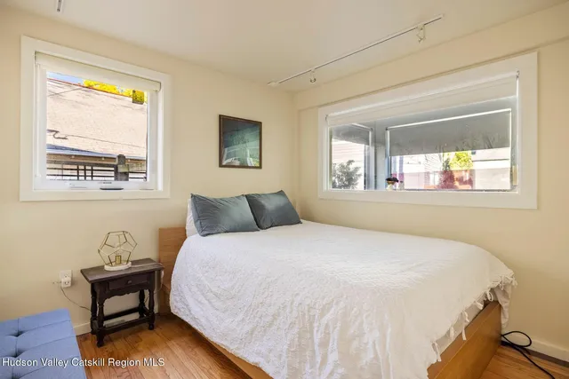 a bedroom with a bed and wooden floor