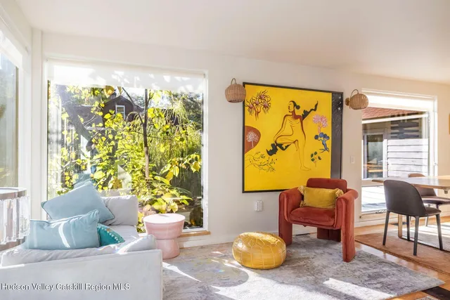 a living room with furniture and a floor to ceiling window