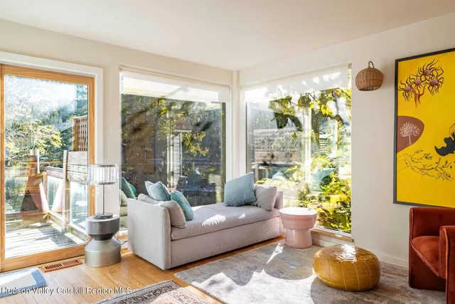 a living room with patio furniture and a potted plant
