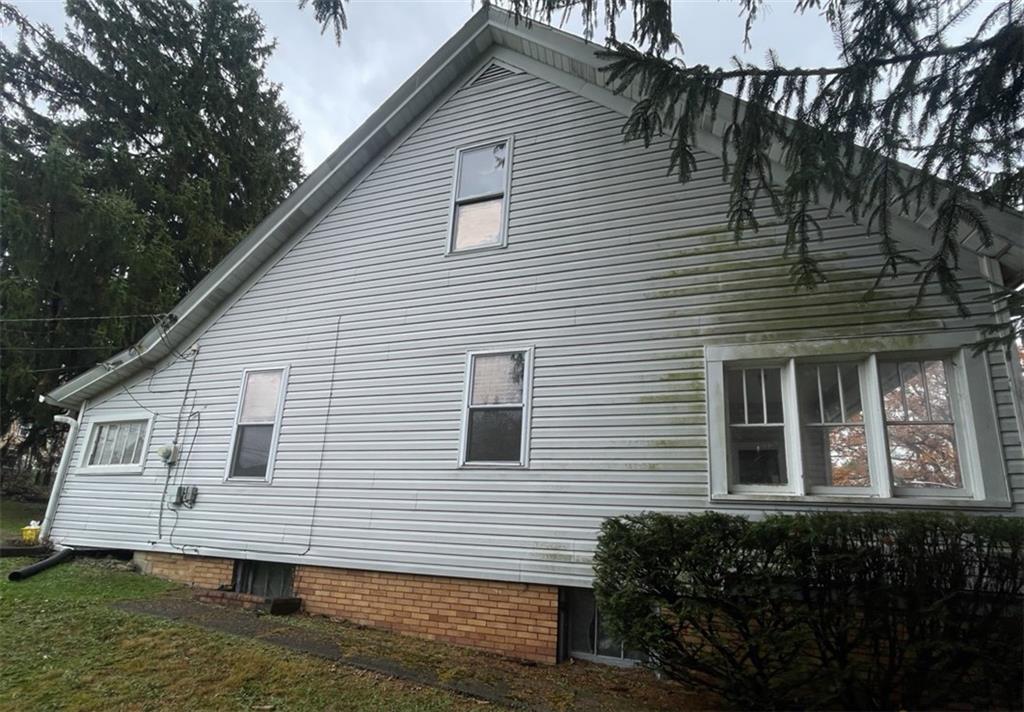 2409 25th Street Beaver Falls, PA 15010 - Photo 2 of 20 a view of a house with a yard and large tree