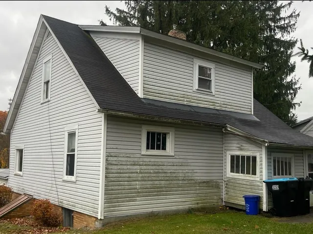a view of a house with a backyard