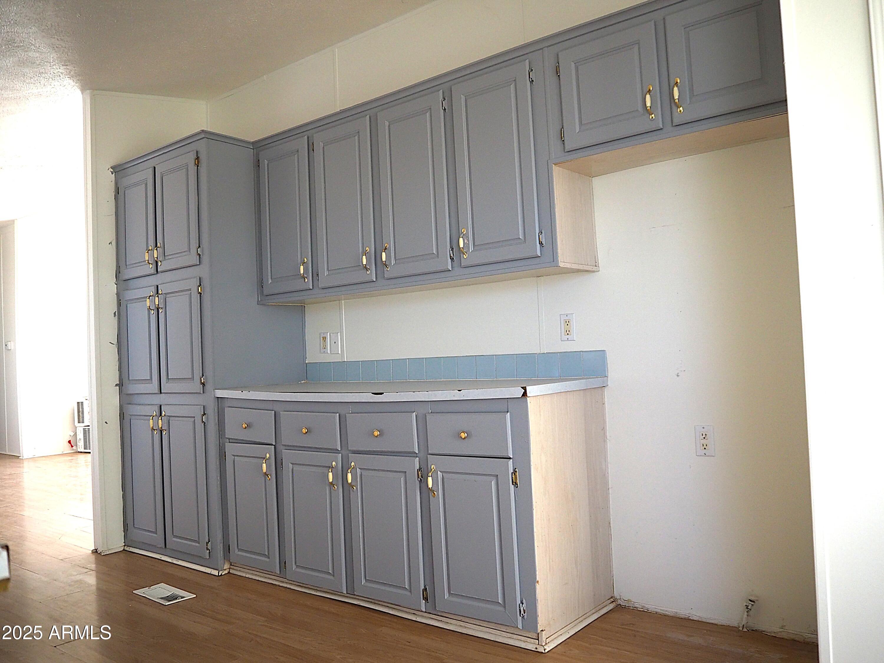 22548 West Skinner Road Wittmann, AZ 85361 - Photo 12 of 25 a view of cabinets and wooden cabinet