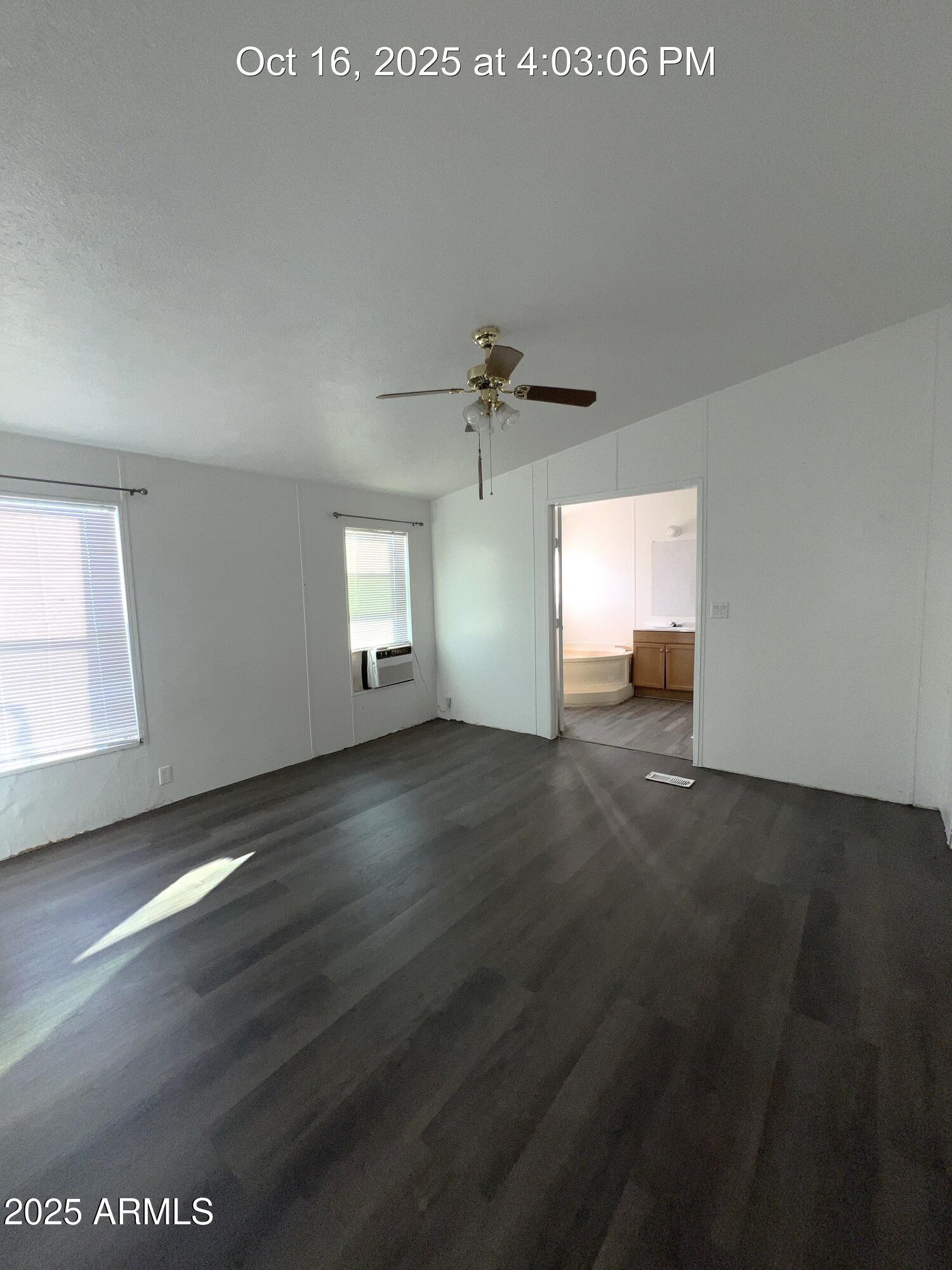 22548 West Skinner Road Wittmann, AZ 85361 - Photo 23 of 25 an empty room with wooden floor and windows