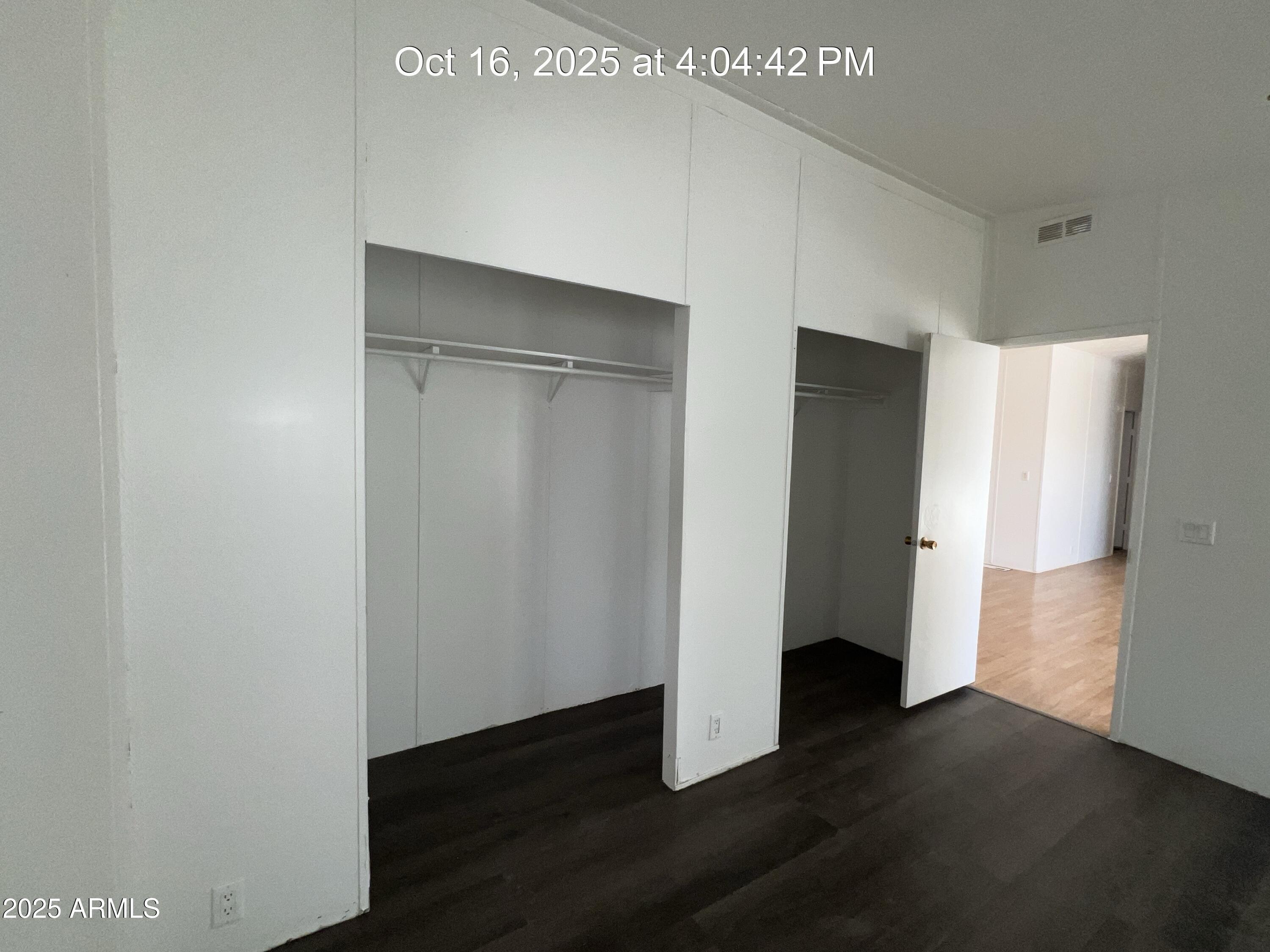 22548 West Skinner Road Wittmann, AZ 85361 - Photo 24 of 25 a view of an empty room with wooden floor and closet