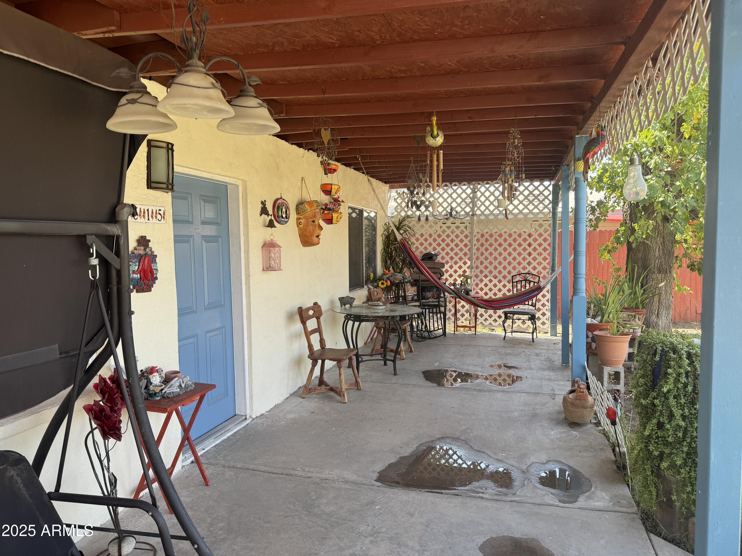 6515 North 59th Drive Glendale, AZ 85301 - Photo 4 of 47 a view of a patio with table and chairs potted plants