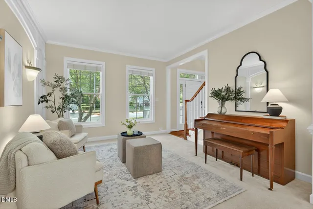 a living room with furniture a potted plant and a large window