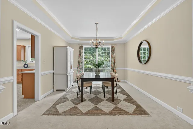 a view of a dining room with furniture and a chandelier