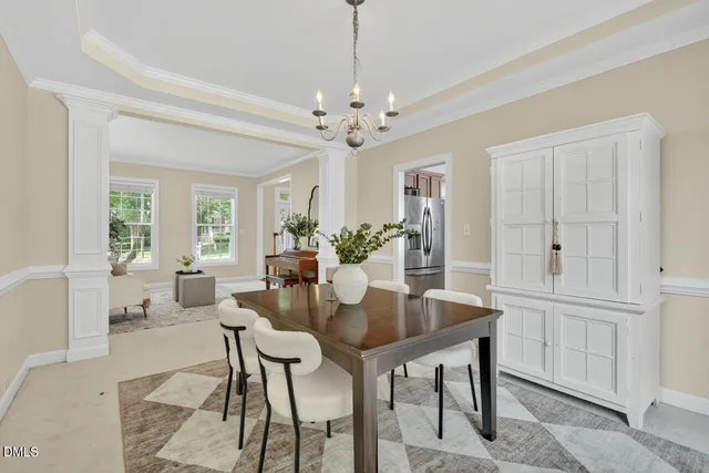 a dining room with furniture and chandelier