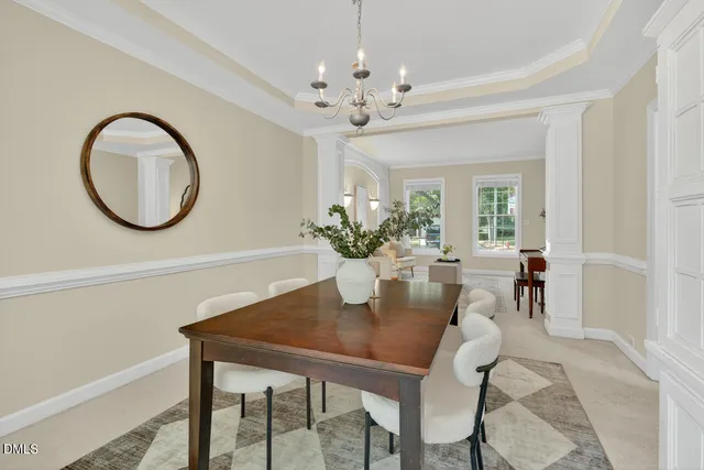 a kitchen with a stove a sink a microwave a dining table and chairs